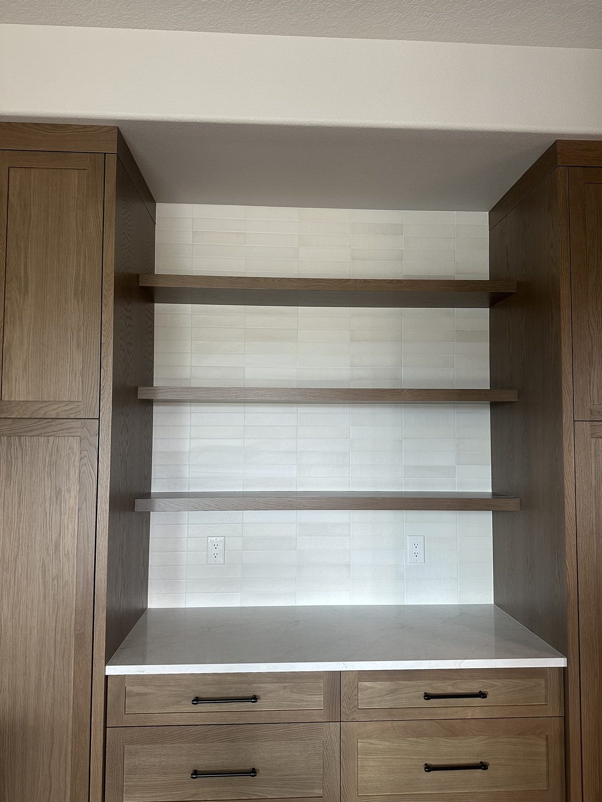 White subway tile backsplash installed behind full-height kitchen cabinetry